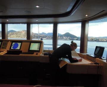 female captain on the bridge of a yacht